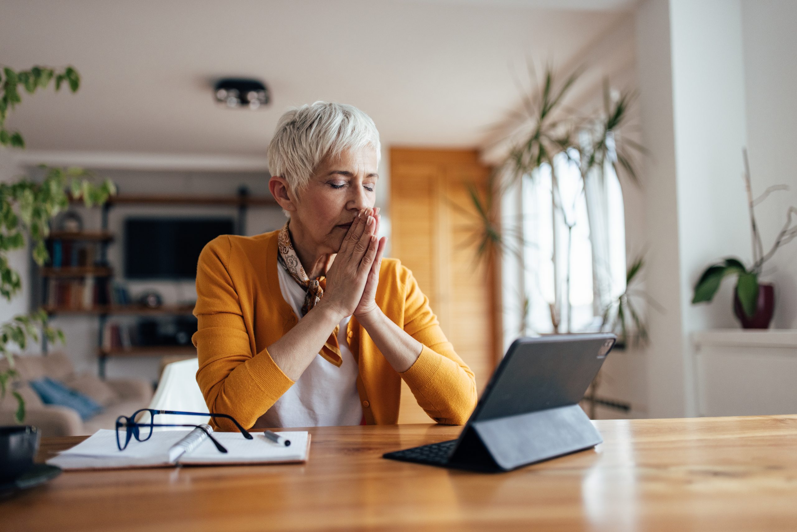 Woman composing herself in front of a tablet