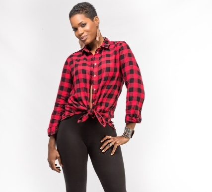 Woman standing at a sassy angle while wearing a red flannel