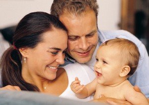 Woman and her husband holding a little baby