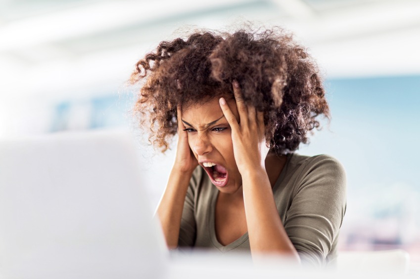 Angry woman holding her hair and yelling