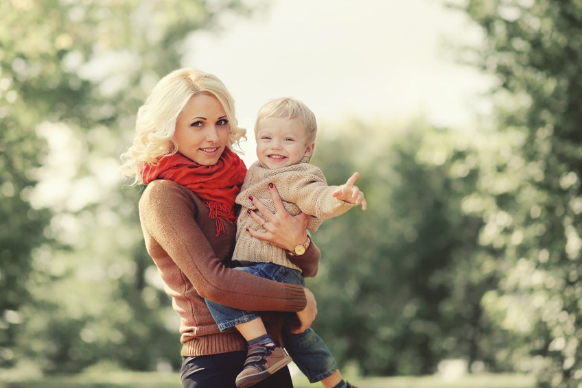 Young mother posing with her baby outdoors