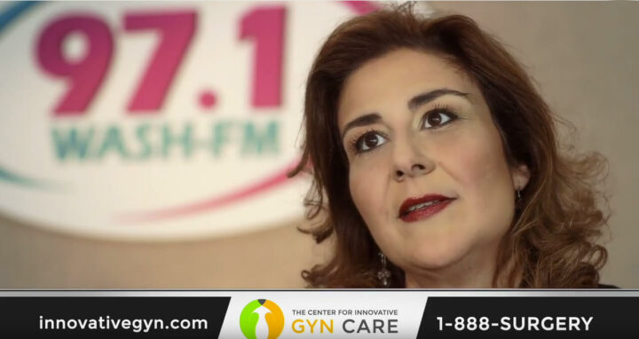 A woman standing in front of a 97.1 WASHFM sign