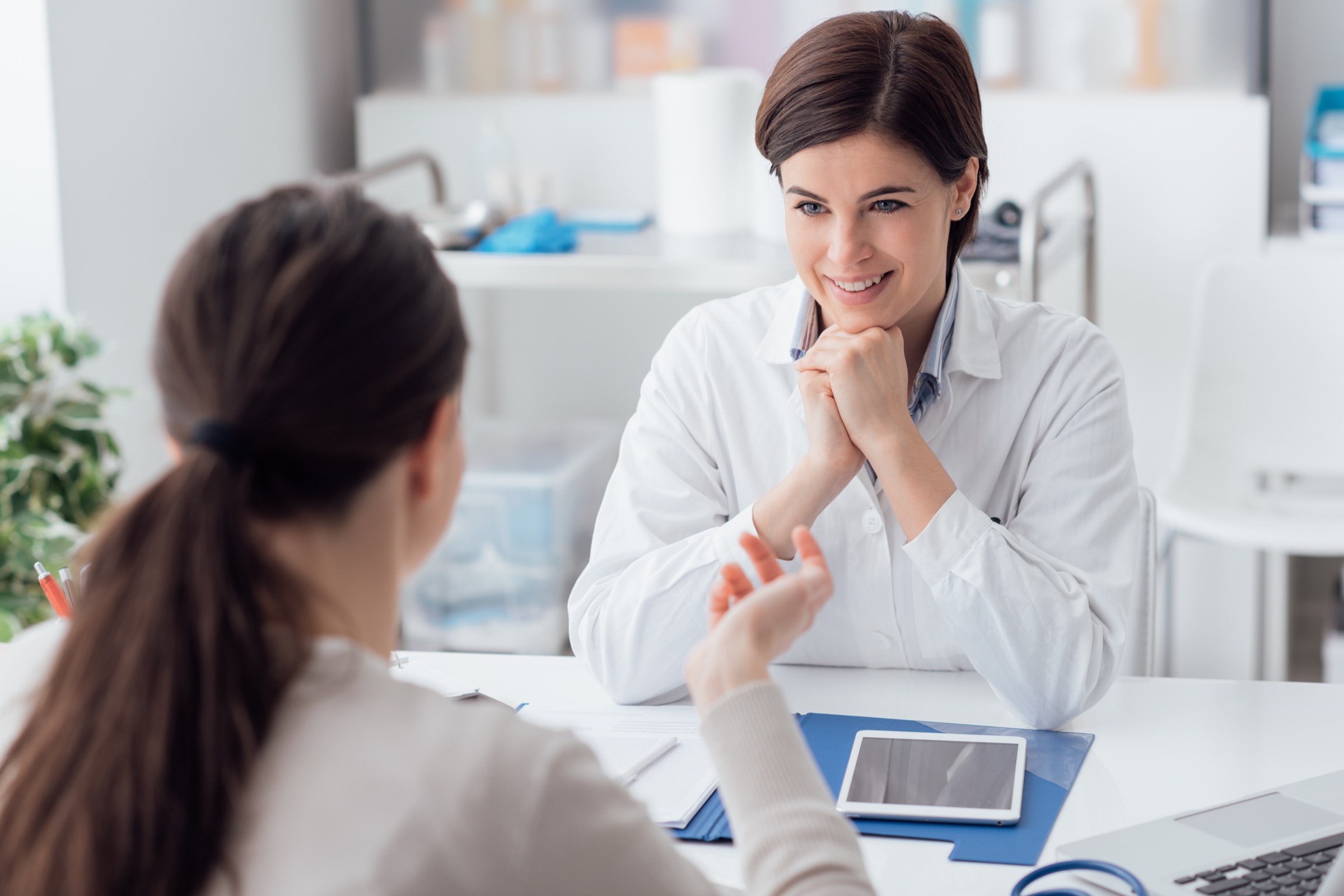 Doctor working in the office and listening to the patient, she is explaining her symptoms, healtcare and assistance concept