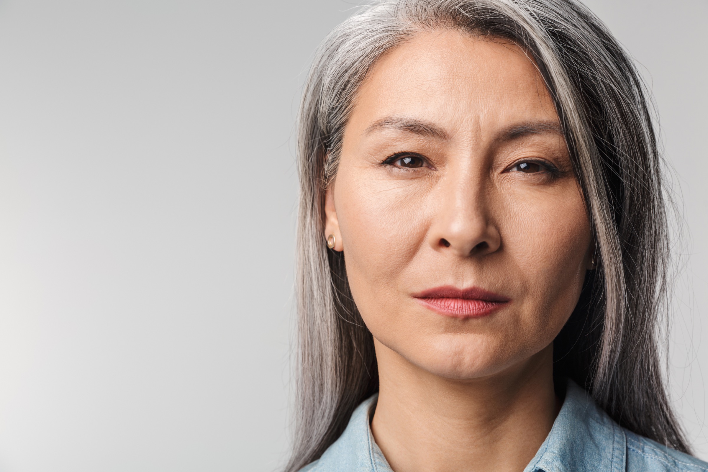 Image of adult mature woman with long white hair looking at camera